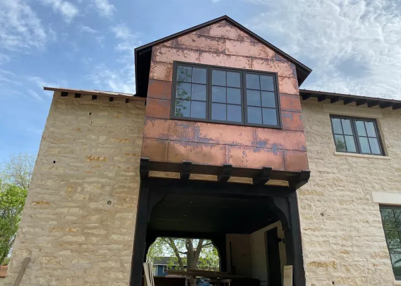 Copper metal panel facade on a stone building for Roof Repair in Hybla Valley